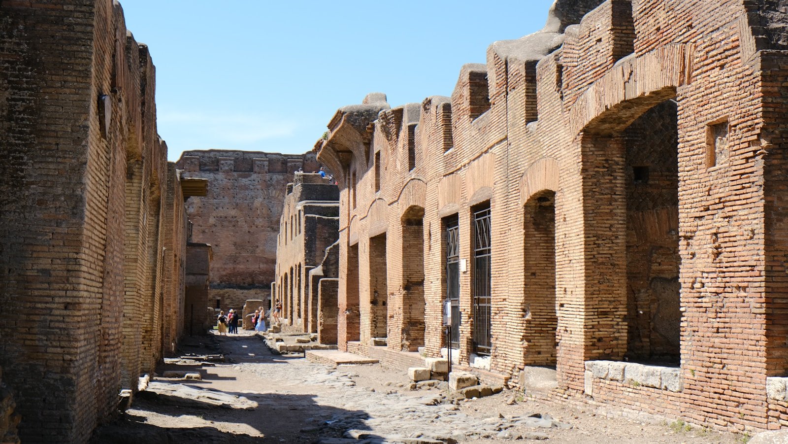a narrow street with brick buildings and a sky background