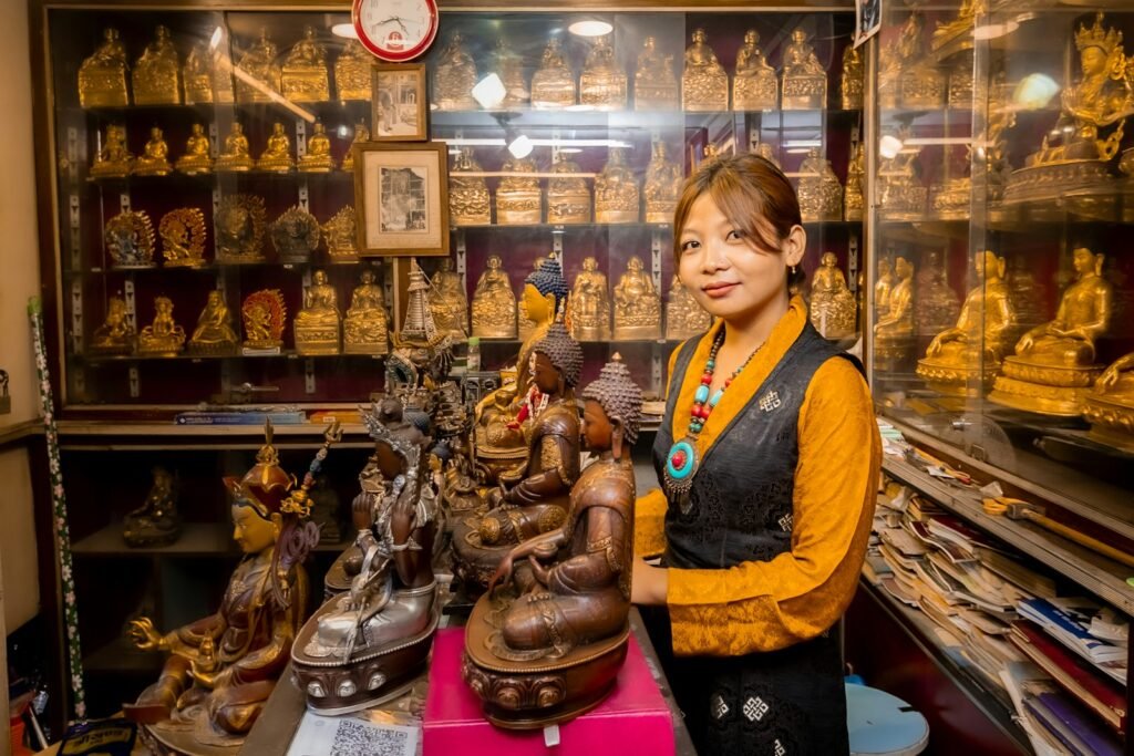 Woman standing in shop filled with buddhist statues